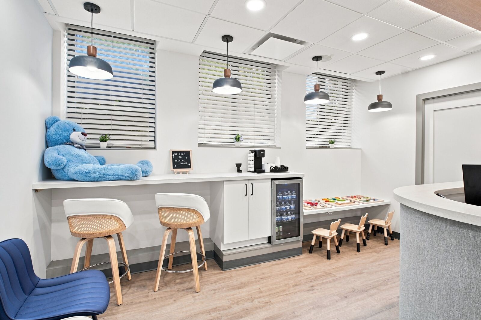 Waiting area with seating, coffee bar and kids' play table